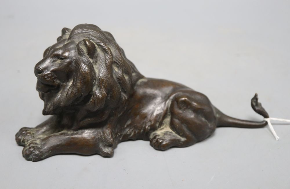 An early 20th century bronze model of a recumbent lion, length 23cm